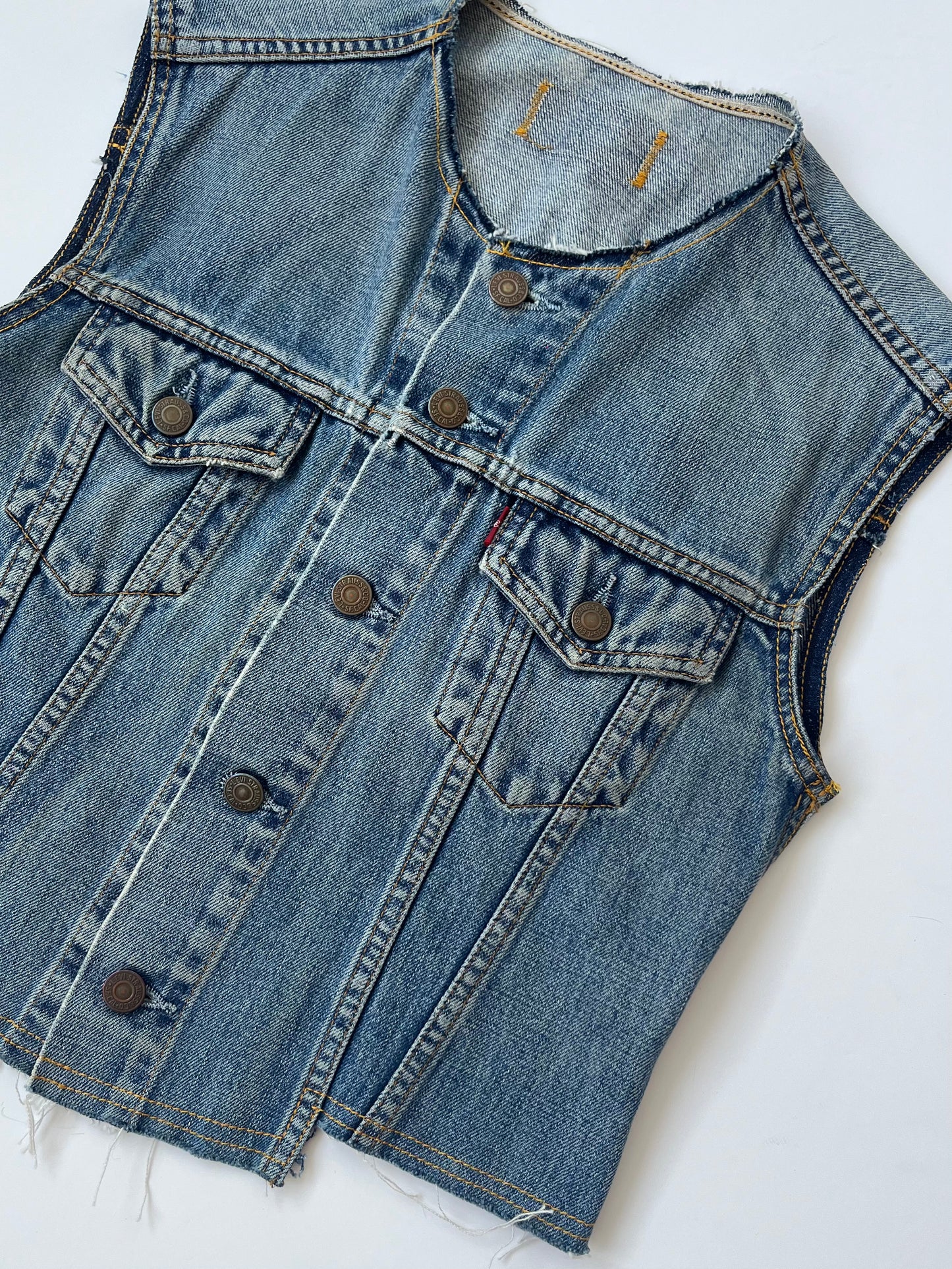 Berta mid wash denim waistcoat with stepped hem detail